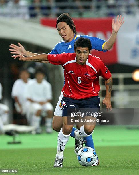 Yasuhito Endo of Japan and Edson Puch of Chile compete for the ball during Kirin Cup soccer match between Japan and Chile at Nagai Stadium on May 27,...