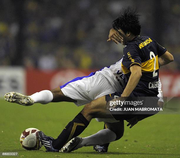 Uruguay's Defensor Sporting forward Diego Vera vies for the ball with Argentina's Boca Juniors defender Julio Cesar Caceres during a Libertadores Cup...