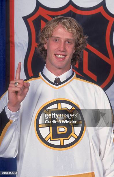Portrait of Canadian ice hockey player Joe Thornton, in the jersey of the Boston Bruins, following his first round, first place selection in the NHL...