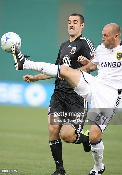 Andrew Jacobson of D.C. United watches Clint Mathis of Real Salt Lake clear the ball during an MLS match at RFK Stadium on May 23, 2009 in...