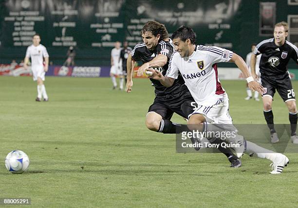 Dejan Jakovic of D.C. United races for the ball with Javier Morales of Real Salt Lake during an MLS match at RFK Stadium on May 23, 2009 in...