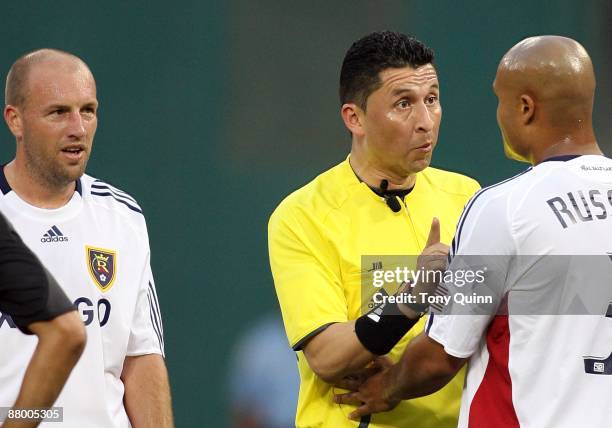 Robbie Russell of Real Salt Lake is lectured by referee Jorge Gonzalez during an MLS match against D.C. United at RFK Stadium on May 23, 2009 in...
