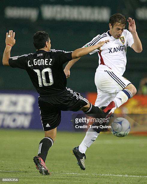 Christian Gomez of D.C. United pokes the ball away from Yura Movsisyan of Real Salt Lake during an MLS match at RFK Stadium on May 23, 2009 in...