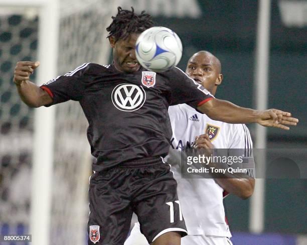 Luciano Emilio of D.C. United heads the ball down in front of Robbie Russell of Real Salt Lake during an MLS match at RFK Stadium on May 23, 2009 in...