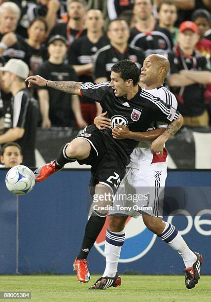 Santino Quaranta of D.C. United is grabbed by Robbie Russell of Real Salt Lake during an MLS match at RFK Stadium on May 23, 2009 in Washington, DC....