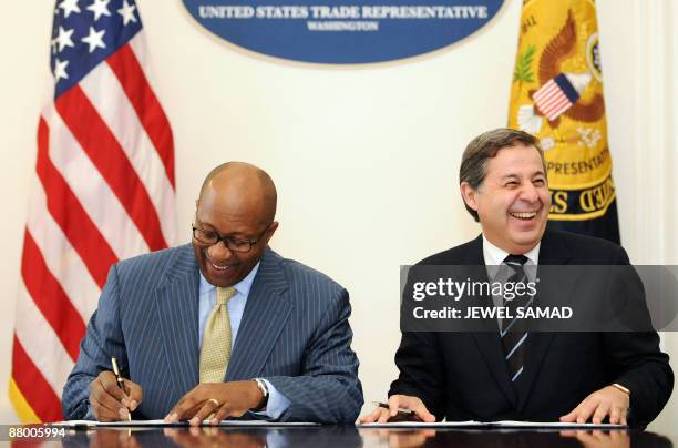 United States Trade Representative Ron Kirk and Egypt's Trade Minister Rachid Mohamed Rachid sign an agreement at the Office of the US Trade...