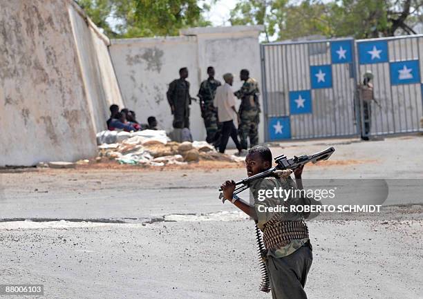 Armed men working for the transitional federal government stand outside the gate to the Somali President's house, within the presidential compound,...