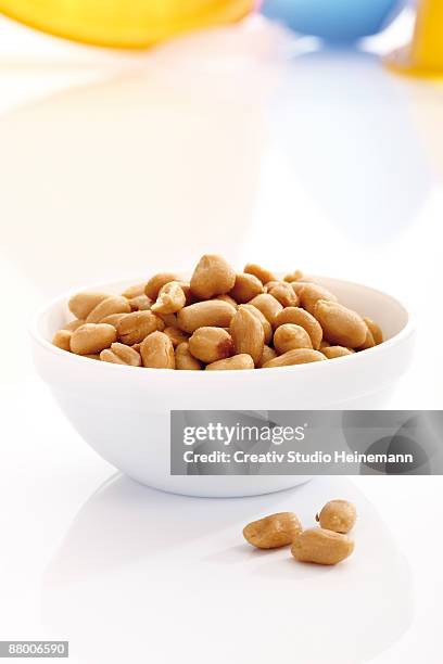 peanuts in bowl - peanuts stock pictures, royalty-free photos & images