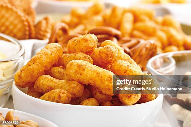 assorted snacks, peanut puffs in bowl, close-up - salted peanuts stock pictures, royalty-free photos & images