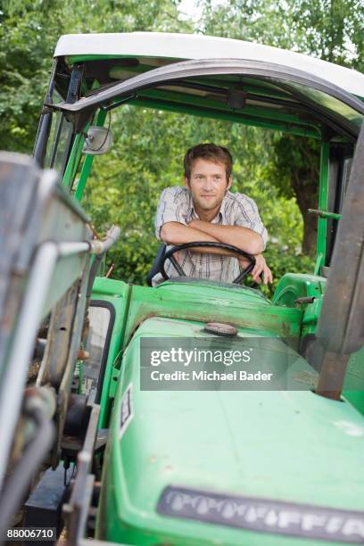 farmer sitting in tractor - saxony stock pictures, royalty-free photos & images