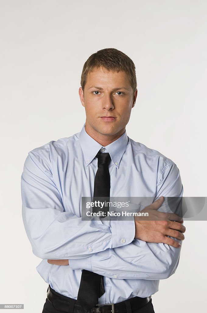 Businessman standing, arms folded