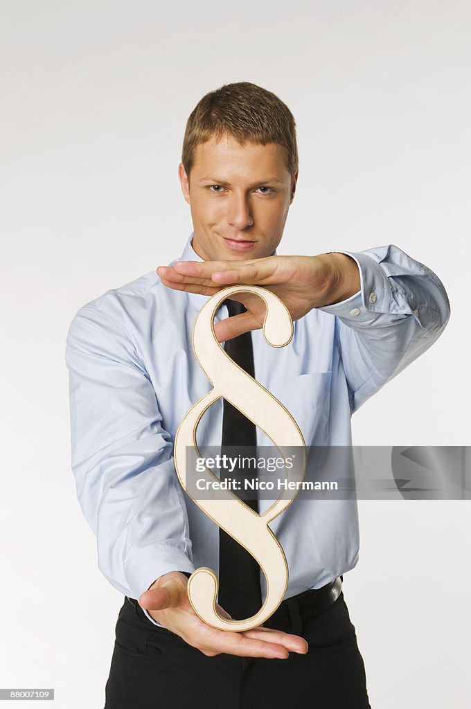 Businessman holding paragraph sign