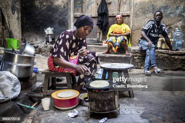 Street vendor cooks fresh chapati breads for sale on a small stove in a narrow back street in Mombasa, Kenya, on Thursday, Nov. 23, 2017. The...