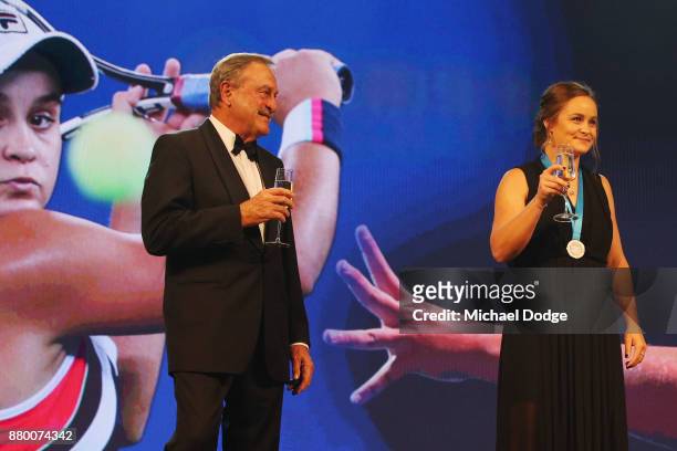 John Newcombe medallist Ashleigh Barty stands on the podium with John Newcombe at the 2017 Newcombe Medal at Crown Palladium on November 27, 2017 in...
