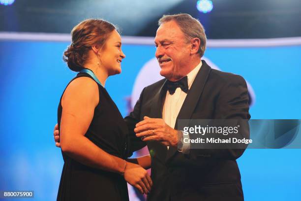 John Newcombe medallist Ashleigh Barty accepts her award on the podium from John Newcombe at the 2017 Newcombe Medal at Crown Palladium on November...