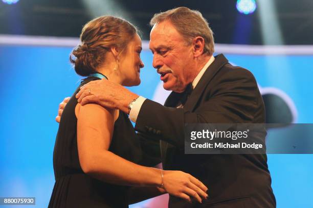 John Newcombe medallist Ashleigh Barty accepts her award on the podium from John Newcombe at the 2017 Newcombe Medal at Crown Palladium on November...