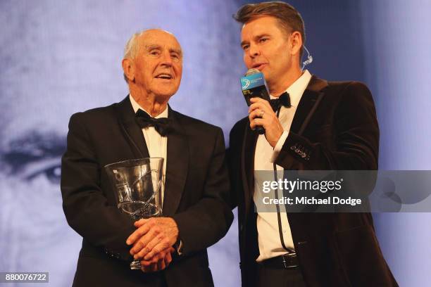 Former Premier of Victoria John Cain speaks with former tennis player Todd Woodbridge on stage at the 2017 Newcombe Medal at Crown Palladium on...