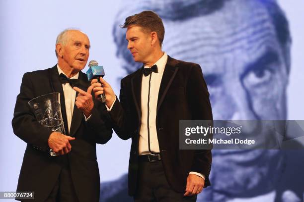 Former Premier of Victoria John Cain speaks with former tennis player Todd Woodbridge on stage at the 2017 Newcombe Medal at Crown Palladium on...