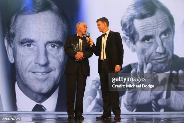 Former Premier of Victoria John Cain speaks with former tennis player Todd Woodbridge on stage at the 2017 Newcombe Medal at Crown Palladium on...