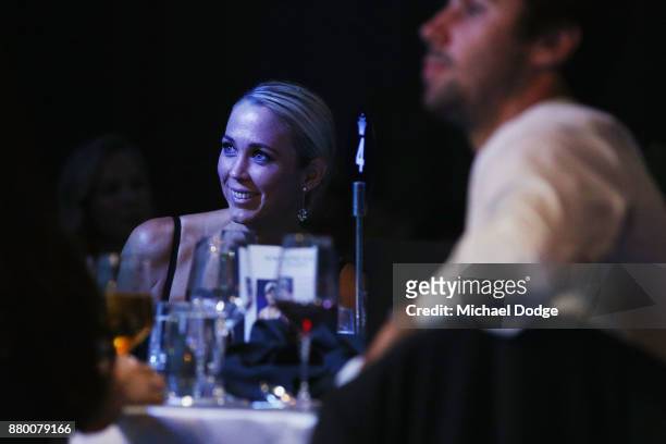 Bec Cartwright listens to husband and former tennis players Lleyton Hewitt speak on stage at the 2017 Newcombe Medal at Crown Palladium on November...
