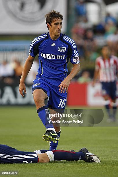 Josh Wolff of the Kansas City Wizards steps over a Chivas USA defender during the game at Community America Ballpark on May 23, 2009 in Kansas City,...