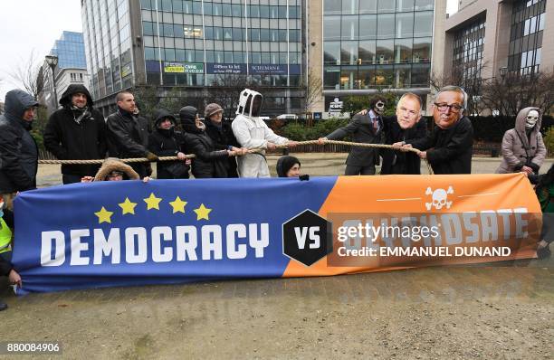 Activists acting as European Commission President Jean-Claude Juncker , EU Commissioner in charge of Health and Food safety Vytenis Andriukaitis and...