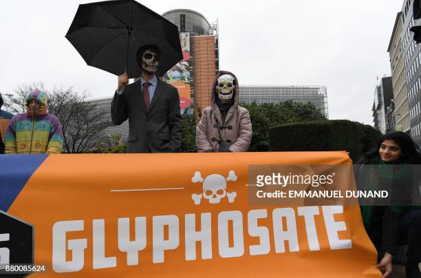 Activists acting as Monsanto-characters with their faces painted with skulls take part in an action calling for the EU Commission to vote against the...