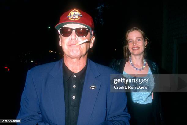 American actor Jack Nicholson smokes hit unlit cigarette as he walks with his girlfriend Rebecca Broussard circa June, 1992 in Los Angeles,...
