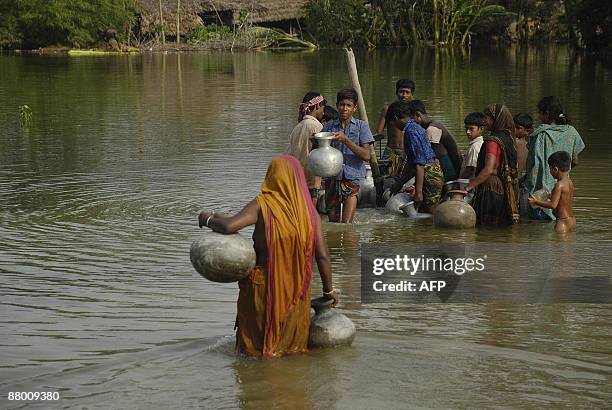 Bangladeshi flood effected villagers collect drinking water in a flooded area in the Koira on the outskirts of Khulna some 400 Kilometers from Dhaka...