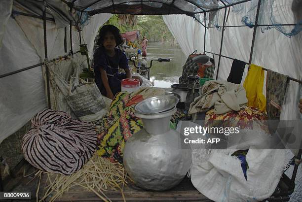 Bangladeshi displaced villager takes shelter after homes were flooded in the Koira area on the outskirts of Khulna some 400 km from Dhaka on May 27,...