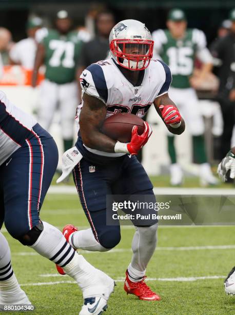 Mike Gillislee of the New England Patriots runs through a hole in the line during an NFL football game against the New York Jets on October 15, 2017...