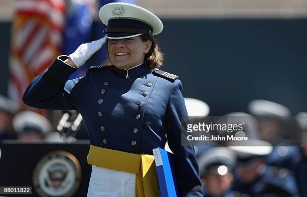 An Air Force Academy graduate salutes after receiving her diploma at the U.S. Air Force Academy graduation ceremony at Falcon Stadium on May 27, 2009...