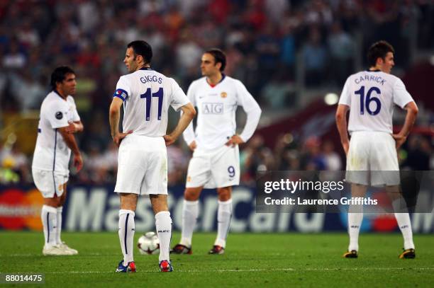 Ryan Giggs of Manchester United and his team mates looks dejected after Lionel Messi of Barcelona scored the second goal for Barcelona during the...