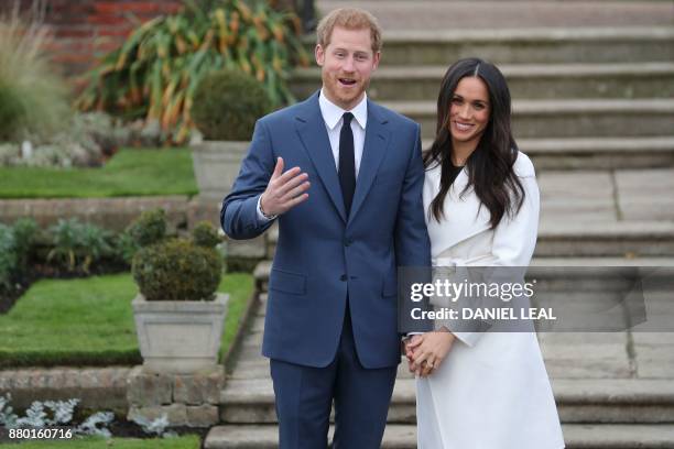 Britain's Prince Harry and his fiancée US actress Meghan Markle pose for a photograph in the Sunken Garden at Kensington Palace in west London on...