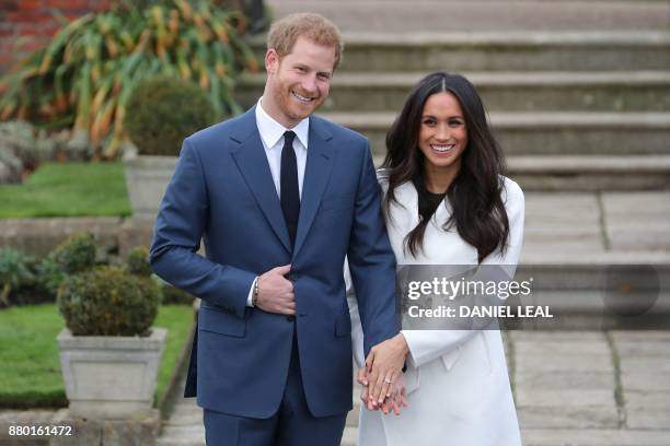 Britain's Prince Harry and his fiancée US actress Meghan Markle pose for a photograph in the Sunken Garden at Kensington Palace in west London on...