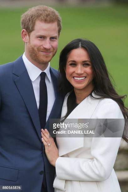 Britain's Prince Harry and his fiancée US actress Meghan Markle pose for a photograph in the Sunken Garden at Kensington Palace in west London on...