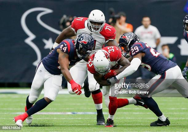 Kerwynn Williams of the Arizona Cardinals is tackled by Jelani Jenkins of the Houston Texans and Andre Hal at NRG Stadium on November 19, 2017 in...