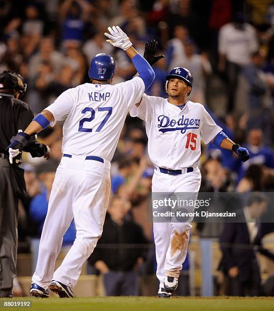 Matt Kemp of the Los Angeles Dodgers is congratulated by Rafael Furcal after he scored the winning run after a bases loaded walk to teammate Juan...