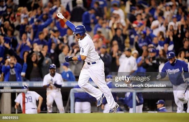 Matt Kemp of the Los Angeles Dodgers celebrates as he scores the winning run after a bases loaded walk to teammate Juan Pierre against relief pitcher...