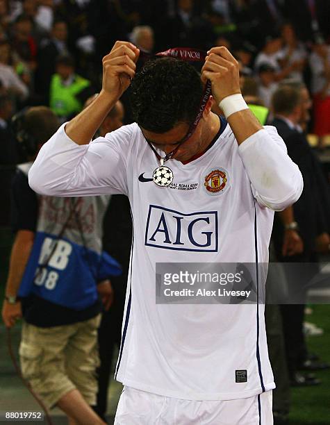 Cristiano Ronaldo of Manchester United takes of his medal after Manchester United lost the UEFA Champions League Final match between Barcelona and...