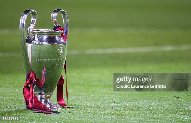 The Champions League trophy sits on the grass after the UEFA Champions League Final match between Manchester United and Barcelona at the Stadio...