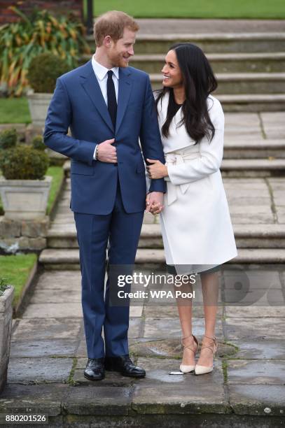 Prince Harry and actress Meghan Markle during an official photocall to announce their engagement at The Sunken Gardens at Kensington Palace on...