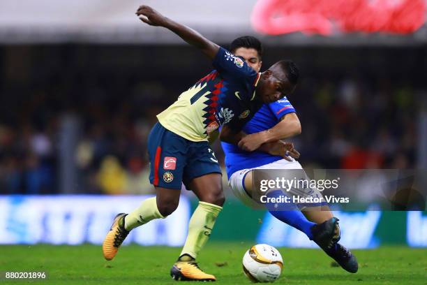 Darwin Quintero of America struggles for the ball with Francisco Silva of Cruz Azul during the quarter finals second leg match between America and...