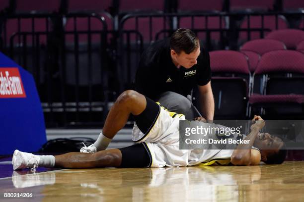 Torry Johnson of the Northern Arizona Lumberjacks is tended to by a trainer after a hard fall against the UC Irvine Anteaters during the 2017...
