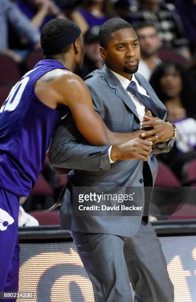 Xavier Sneed of the Kansas State Wildcats runs into head coach Maurice Joseph of the George Washington Colonials during the 2017 Continental Tire Las...