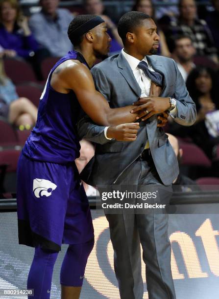 Xavier Sneed of the Kansas State Wildcats runs into head coach Maurice Joseph of the George Washington Colonials during the 2017 Continental Tire Las...