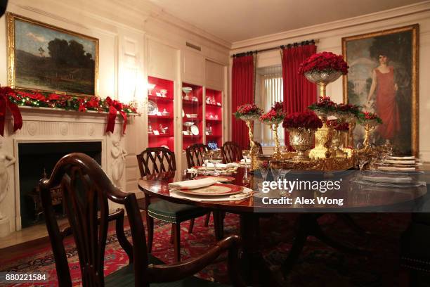 Place setting are seen on a dining table in the China Room at the White House during a press preview of the 2017 holiday decorations November 27,...