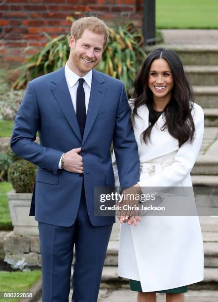 Prince Harry and actress Meghan Markle during an official photocall to announce their engagement at The Sunken Gardens at Kensington Palace on...