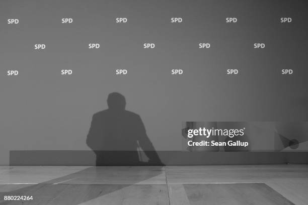 Martin Schulz, leader of the German Social Democrats , casts a shadow as he speaks to the media following a meeting of the SPD leadership on November...