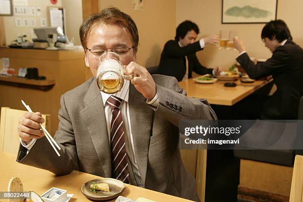 man drinking beer in the japanese-style pub - サラリーマン 酒 ストックフォトと画像